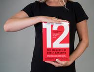 Person holding 12: The Elements of Great Managing
