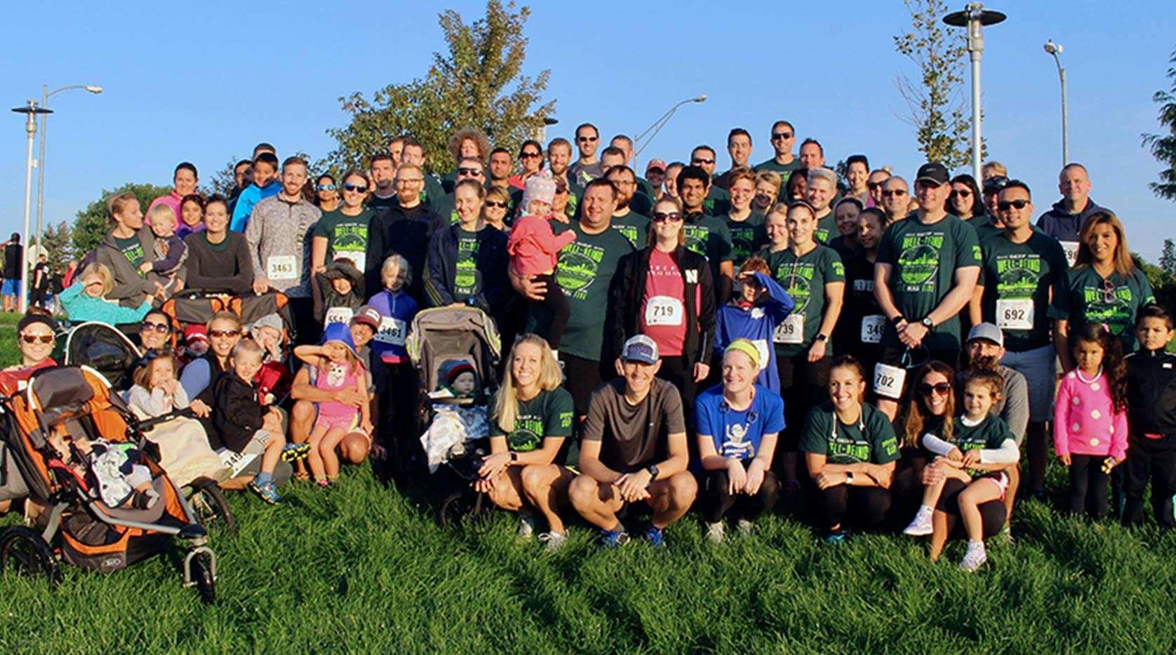 A large group of athletes and families grouped on a hill.
