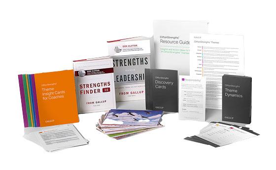 CliftonStrengths books, guides, and coaching cards displayed