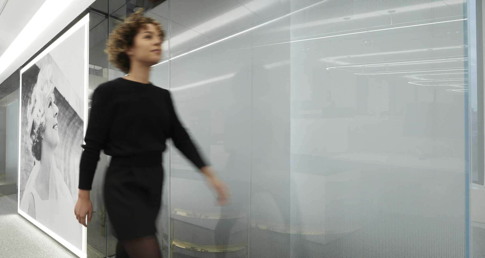 Estée Lauder Companies employee walking in office hall