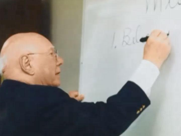 Don Clifton writing on a whiteboard while teaching a course at the University of Nebraska-Lincoln