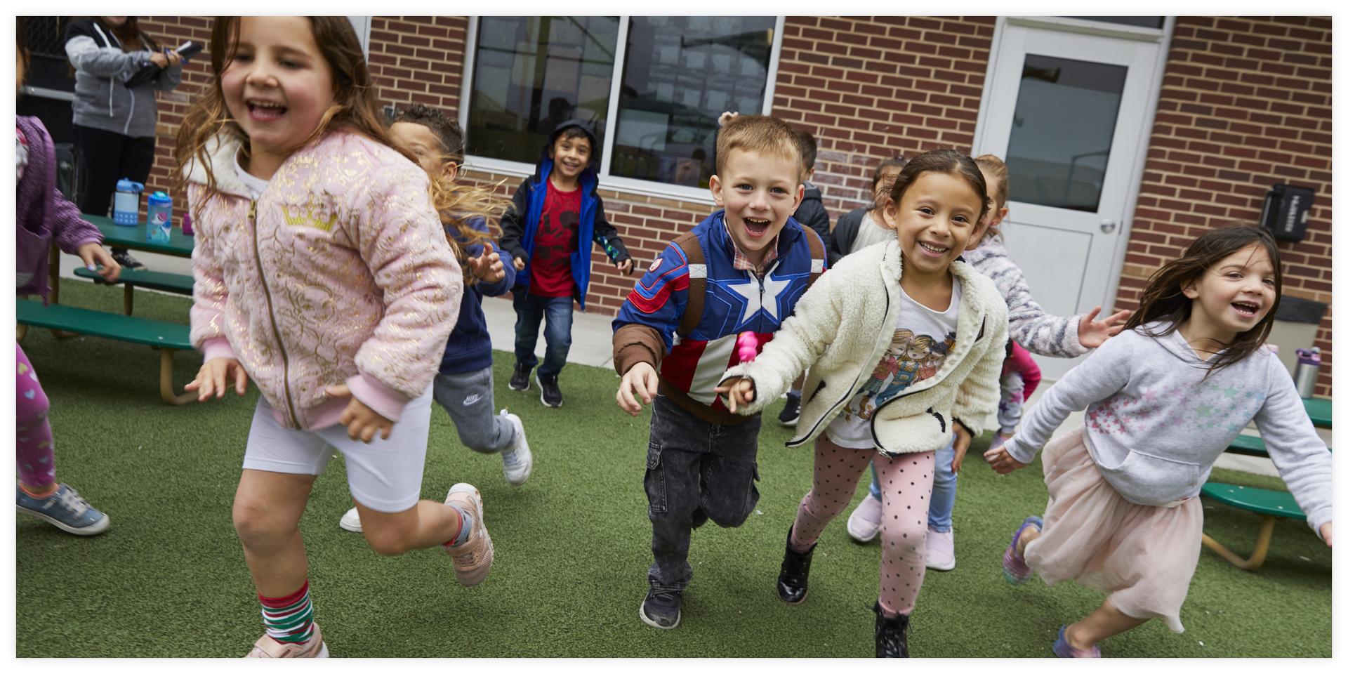 Group of happy children running outside