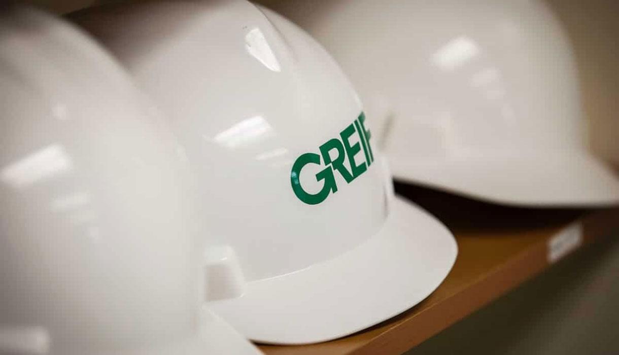 A white hard hat with the green GREIF logo, shown in close-up detail.