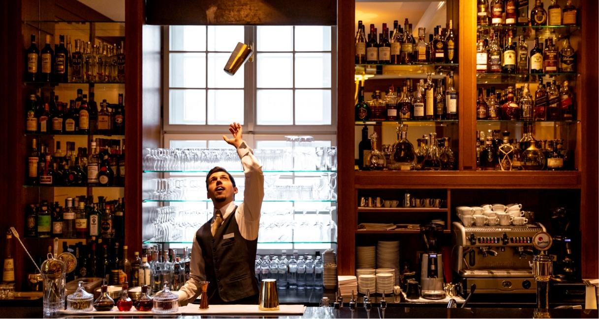 bartender tossing shaker into the air