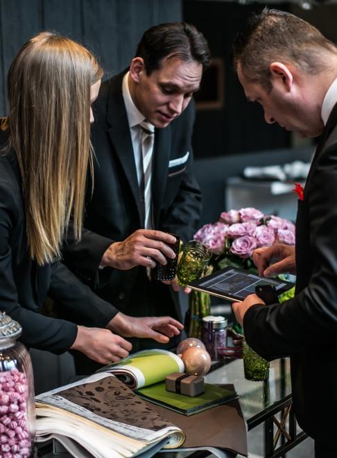 three employees discussing colors and patterns for an event