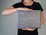 Click this thumbnail to show image: Person holding the Creating an Engaging Workplace Manager Packet.