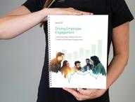 Person holding the Driving Employee Engagement Workbook.