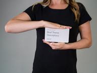 Click this thumbnail to show image: Person holding CliftonStrengths Brief Theme Definitions Card.