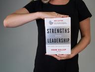 Person holding Strengths Based Leadership