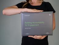 Click this thumbnail to show image: Person holding the Building Accountability for Engagement Manager Packet.