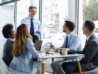 Click this thumbnail to show image: Manager coaching a group of employees.